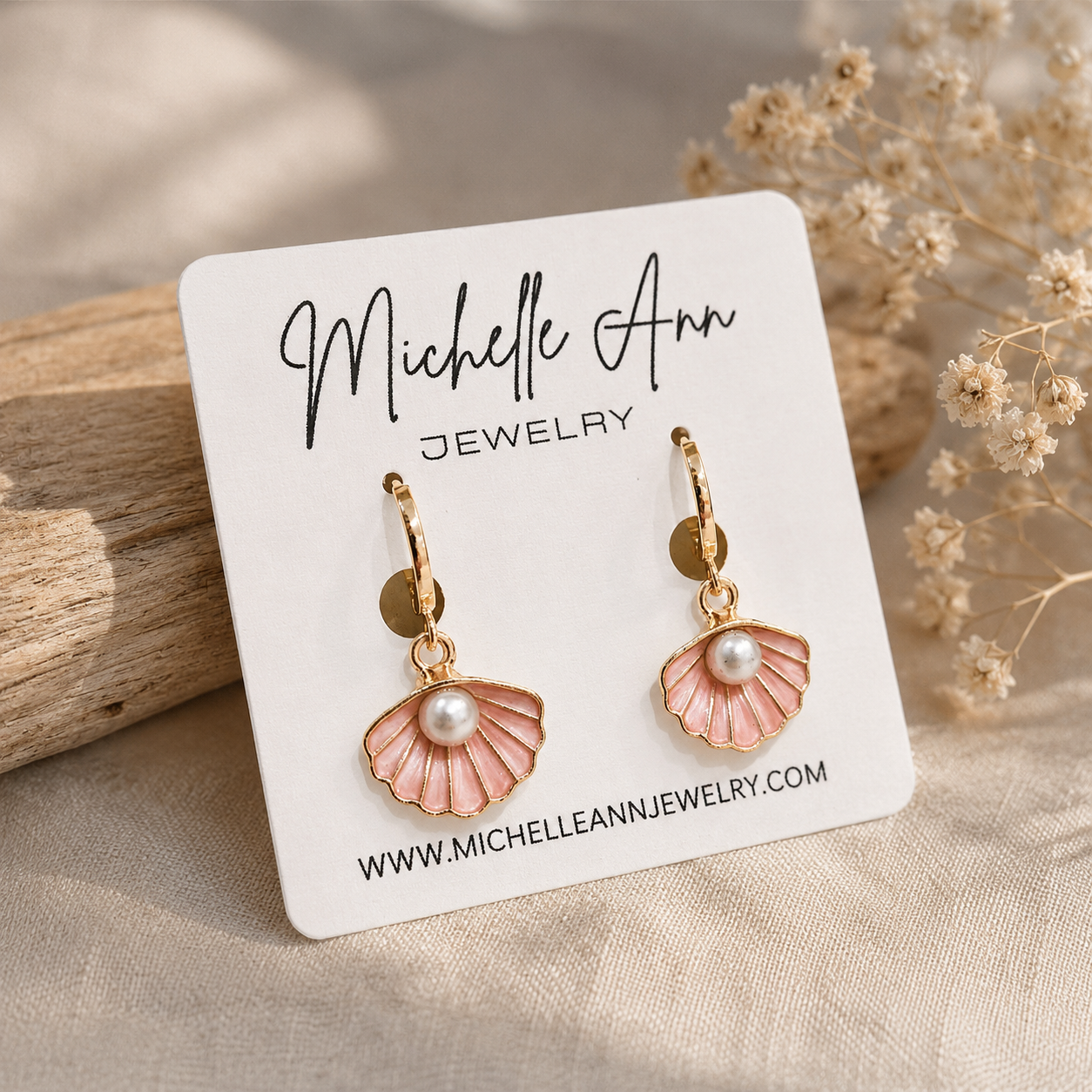 Delicate pink and gold shell earrings with pearls, shown on a branded earring card from Michelle Ann Jewelry.