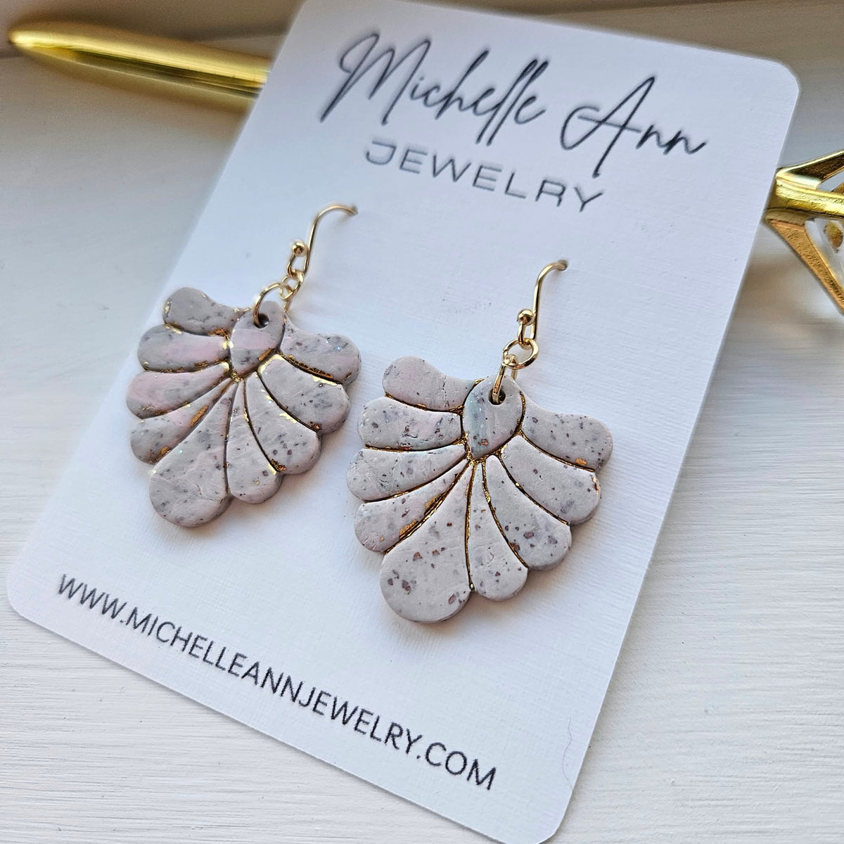 Blush pink and ivory speckled polymer clay fan earrings displayed on a Michelle Ann Jewelry card.