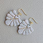 Pair of blush pink and ivory fan-shaped polymer clay earrings with gold details and gold ear wires.